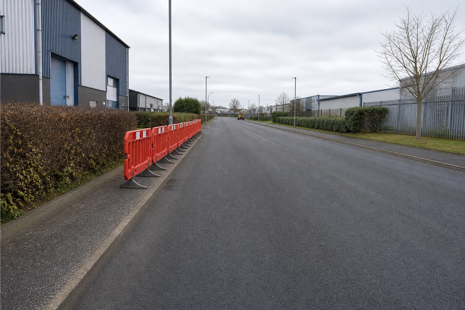 Small controlled work zone beside an open commercial access road
